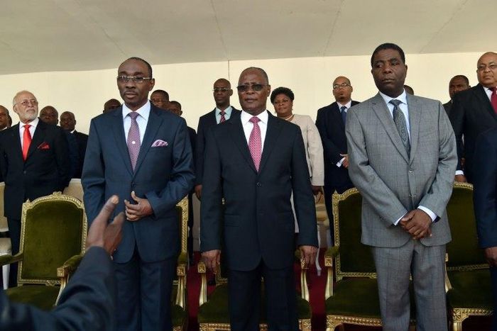 Haitian President Jocelerme Privert (C) stands with the new Prime Minister of Haiti, Enex Jean-Charles (R) and former Prime Minister Evans Paul (L) during the installation of the new government in Port-au-Prince March 28, 2016