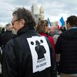 A man wears a poster on his back which translates as "angry policemen" during a demonstration over mounting attacks on officers and to call for reinforcements and more resources, on December 3, 2016 in Marseille, France