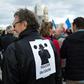 A man wears a poster on his back which translates as "angry policemen" during a demonstration over mounting attacks on officers and to call for reinforcements and more resources, on December 3, 2016 in Marseille, France