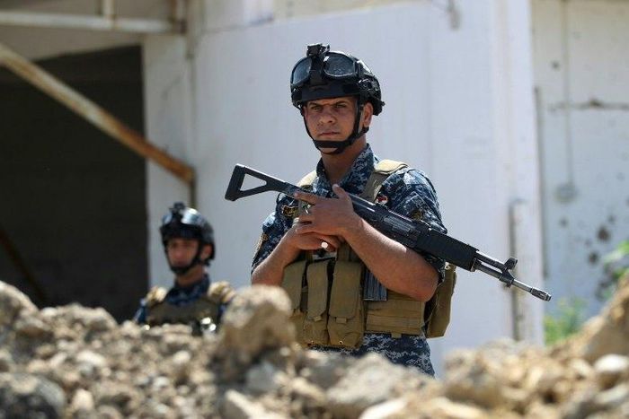 Iraqi security personnel hold a position on the front line in Mosul's Old City on May 3, 2017