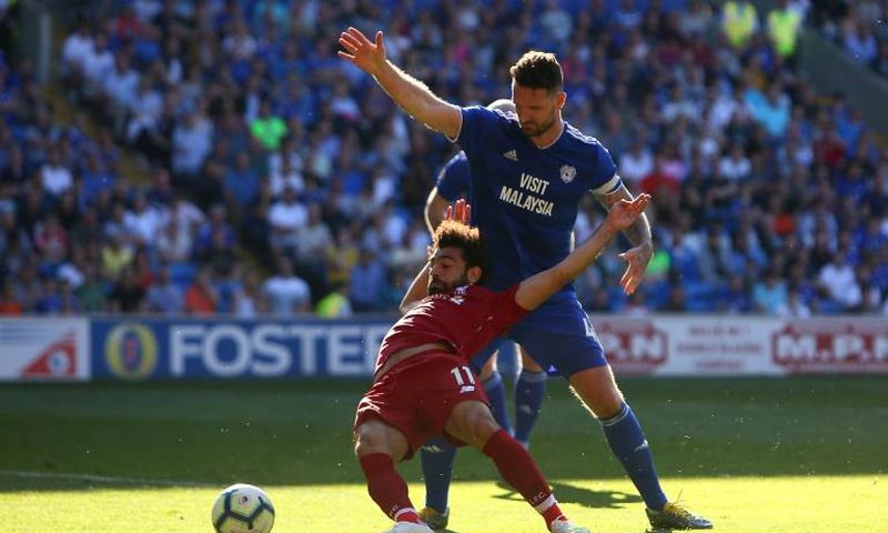 Liverpool's Egyptian forward Salah is fouled by Cardiff defender Morrison
