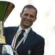 Juventus' coach Massimiliano Allegri poses with the trophy after winning the scudetto at the Juventus Stadium in Turin on May 21, 2017