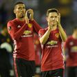 Manchester United's Chris Smalling (L) and Ander Herrera applaud fans at the end of their UEFA Europa League semi-final 1st leg match against Celta Vigo, at the Balaidos stadium in Vigo, on May 4, 2017