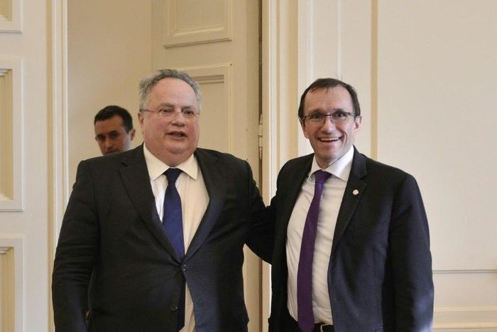 Greek foreign minister Nikos Kotzias (L) poses with UN envoy for Cyprus, Espen Barth Eide prior their meeting in Athens on February 3, 2017