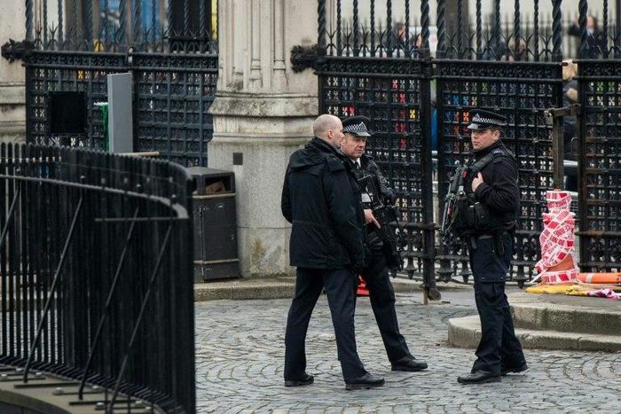 Armed police stand guard at the entrance to the Houses of Parliament which remain closed in central London on March 24, 2017 two days after the March 22 terror attack on the British parliament and Westminster Bridge