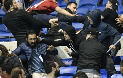 Besiktas' and Lyon's supporters fight before their UEFA Europa League first leg quarter final football match on April 13, 2017, at the Parc Olympique Lyonnais stadium in Decines-Charpieu, central-eastern France