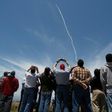 People watch a ground based interceptor missle take off at Vandenberg Air Force base, California on May 30, 2017