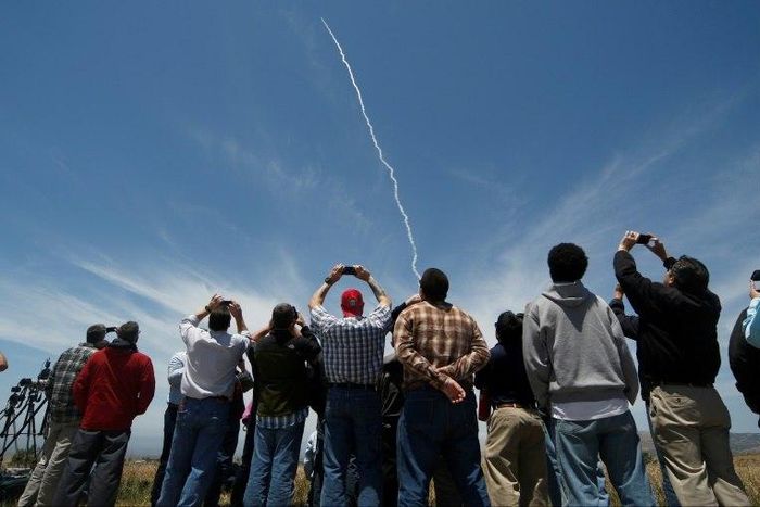 People watch a ground based interceptor missle take off at Vandenberg Air Force base, California on May 30, 2017