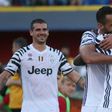 Juventus' Moise Kean (R) celebrates with teammate Medhi Benatia after scoring during their Italian Serie A football match at Bologna on May 27, 2017