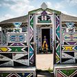 South African artist Esther Mahlangu, 81, whose colourful geometric works are exhibited around the world, stands outside her home in Mpumalanga