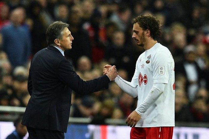 Southampton's manager Claude Puel shakes hands with striker Manolo Gabbiadini during their English League Cup final match against Manchester United, at Wembley stadium in London, on February 26, 2017