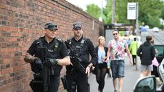 Armed police officers stand guard in Manchester, northwest England, on May 27, 2017