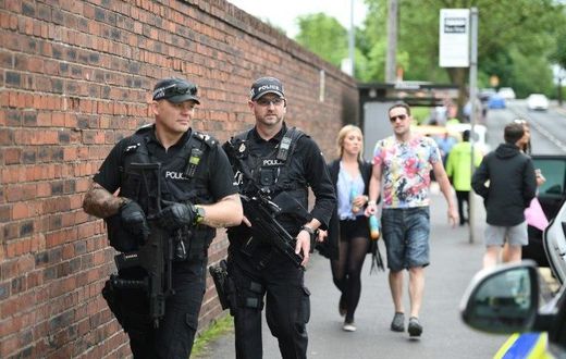 Armed police officers stand guard in Manchester, northwest England, on May 27, 2017
