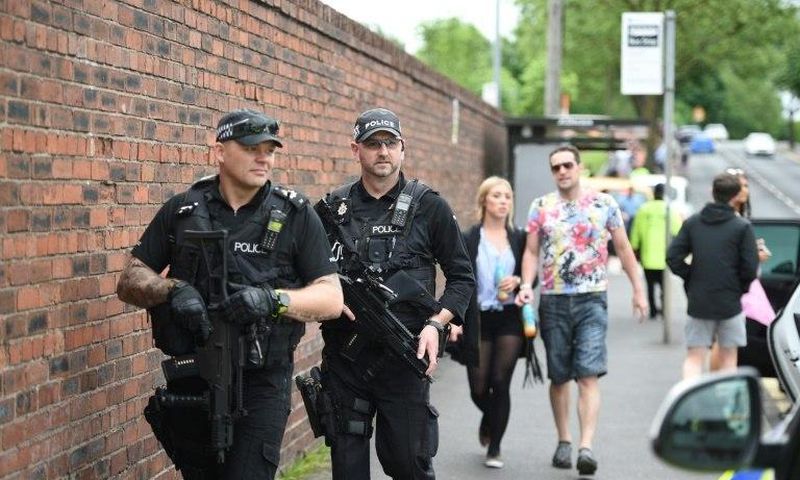 Armed police officers stand guard in Manchester, northwest England, on May 27, 2017