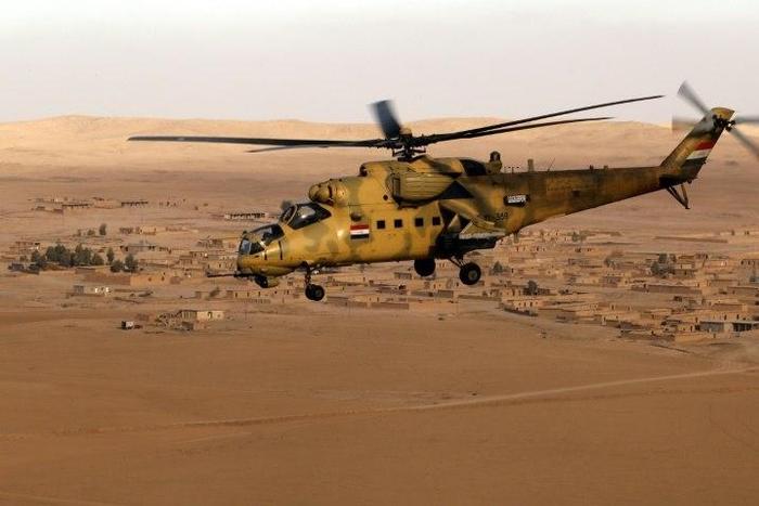 An Iraqi army Mi-35 helicopter flies over the village of Tall Abtah, near the city of Mosul on November 25, 2016