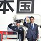 Japan's Prime Minister Shinzo Abe (2nd L) and his wife Akie wave to well-wishers prior to boarding a government plane at Tokyo's Haneda on November 17, 2016