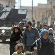 Iraqis leave the Zanjili neighbourhood of west Mosul on June 3, 2017 during the ongoing offensive by security forces to retake the city from Islamic State group fighters