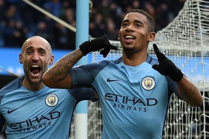 Manchester City's Gabriel Jesus (R) celebrates scoring a late winning goal against Swansea City on February 5, 2017