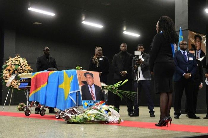 A woman stands in front of the coffin of Democratic Republic of Congo's opposition leader Etienne Tshisekedi during a funeral wake in his honour, in Brussels on February 5, 2017