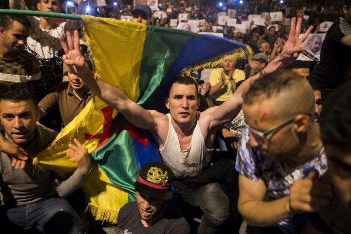 Protestors hold berber flags during a demonstration against corruption, repression and unemployment in Morocco's northern city of al-Hoceima on May 30, 2017