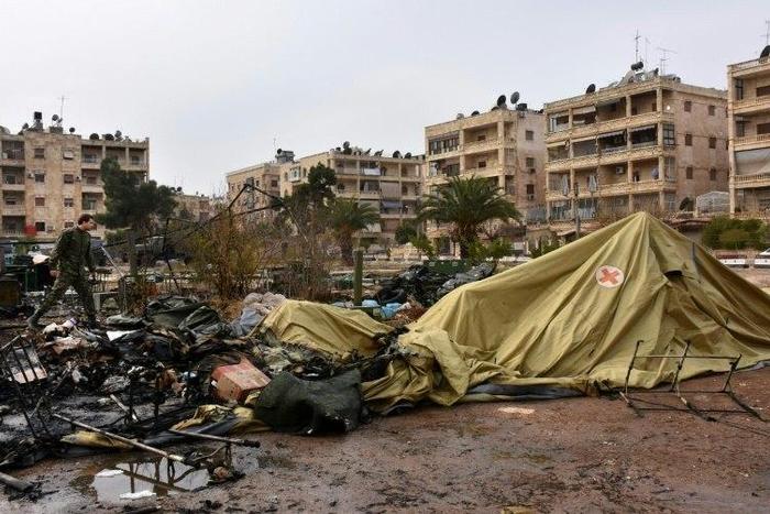 A Russian soldier inspects the damage at a field hospital that was reportedly destroyed by rebel shelling in the Furqan neighbourhood of the government-held side of west Aleppo