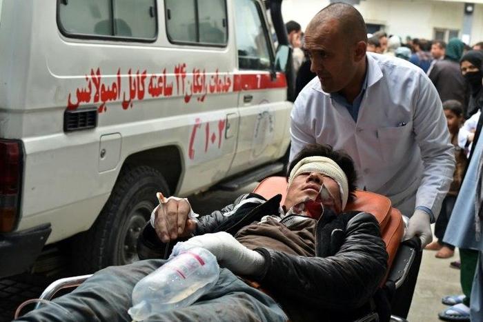 A wounded Afghan man is transferred from an ambulance to hospital after a bombing at a Shiite mosque in Kabul on November 21, 2016