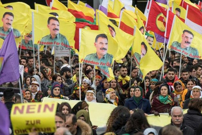 Kurdish protesters demonstrate with placards reading "No to dictatorship" and the portrait of the leader of the Kurdistan PKK Workers' Party, Abdullah Ocalan in the city center of Frankfurt am Main, western Germany, on March 18, 2017