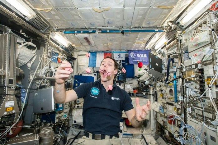 French astronaut Thomas Pesquet displays his juggling and eating skills during a light moment on the International Space Station