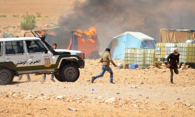 Tunisian protesters comfront security forces outside the El Kamour oil and gas pumping station, in the southern state of Tataouine, on May 22, 2017