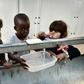 Children brush their teeth at the Souda municipality-run refugee camp on the Greek island of Chios on October 13, 2016