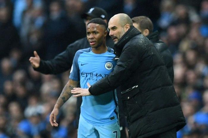 Manchester City's manager Pep Guardiola (R) speaks to midfielder Raheem Sterling during their English Premier League match against Liverpool, at the Etihad Stadium in Manchester, on March 19, 2017