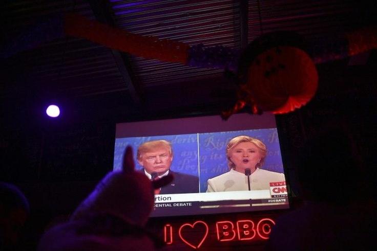 Locals and Americans watch the final presidential debate between Hillary Clinton and Donald Trump at a bar-restaurant in Mexico City