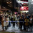 Bystanders gather behind a police cordon outside the Tsim Sha Tsui train station in the Kowloon district of Hong Kong on February 10, 2017, after a fire engulfed a subway train