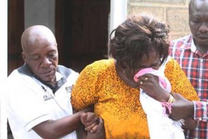 Family members overcome by grief during the burial of Collins Kipyegon Kalya