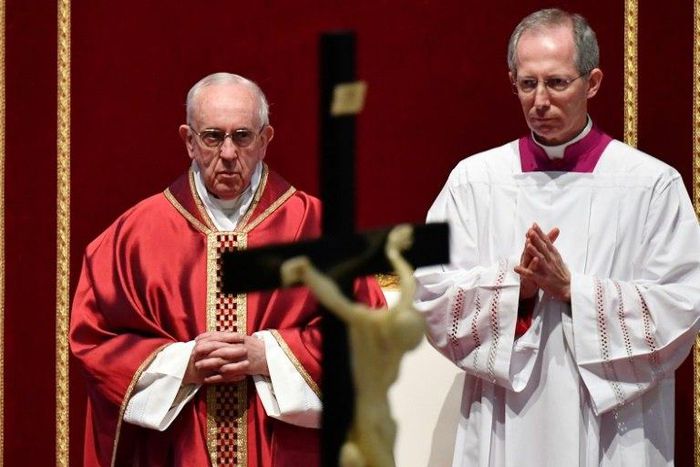 Pope Francis (L) presides over the Celebration of the Lord's Passion on Good Friday at St Peter's basilica, on April 14, 2017 in Vatican