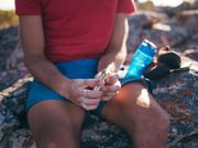 Hands of a climber holding energy bar as snack