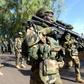 Soldiers from The Gambia and ECOWAS soldiers patrol in front of the Second Infantry Battalion Camp in Farafenni, Gambia on January 22, 2017