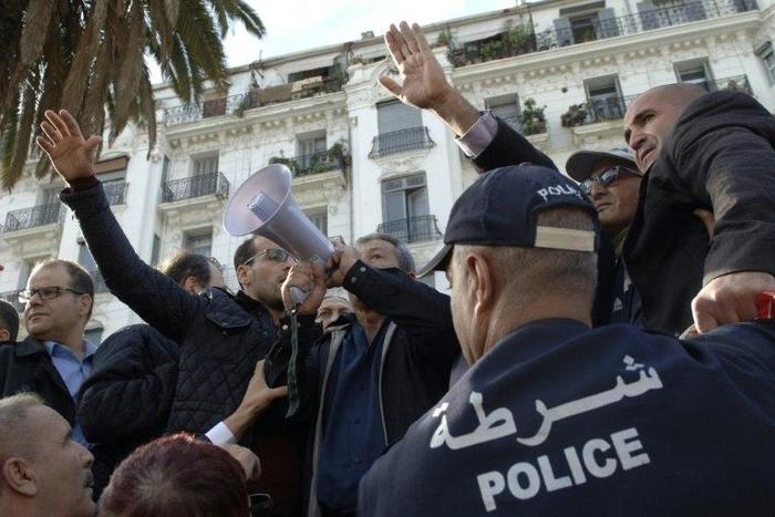 Algerian trade unionists gather outside the People's National Assembly bulding in the capital Algiers on November 27, 2016, to protest a draft law on pension reforms