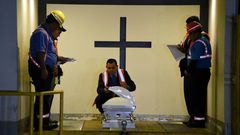Funeral home employees in Guatemala prepare the coffin holding the repatriated body of eight-year-old migrant Felipe Gomez