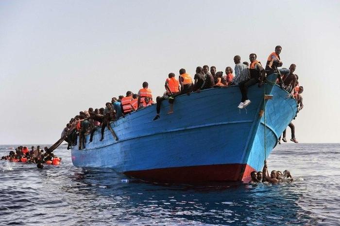 Migrants wait to be rescued in the Mediterranean Sea off the coast of Libya on October 4, 2016