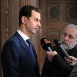 Syrian President Bashar al-Assad (left) speaks to foreign reporters in Damascus, on February 7, 2017