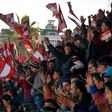 Al-Ittihad supporters wave flags bearing their team's colors for the first Syrian league football match in Aleppo since rebels took over the east part of the Syrian city on January 28, 2017