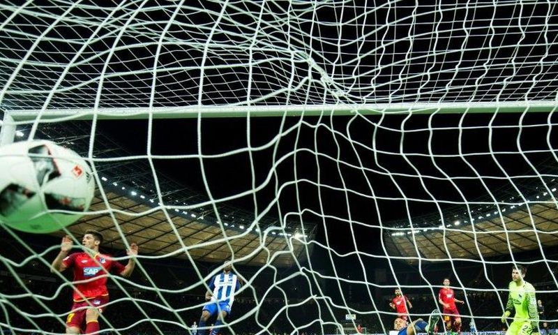 Hoffenheim's forward Andrej Kramaric (L) scores his side's 3rd goal past Hertha Berlin's goalkeeper Rune Jarstein (R) during the German First division Bundesliga football match March 31, 2017