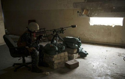 A sniper from the Iraqi federal police unit aims towards an Islamic State group position in the west of Mosul during an ongoing operation to recapture the city from the jihadists in this picture taken on April 12, 2017
