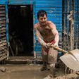 Residents of a populous district of Lima remove mud, debris and water left by a flash flood from their homes, on March 19, 2017