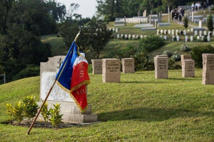 A French flag is draped over a memorial at the Stanley Military Cemetery, dedicated to French civilians who died fighting with the Hong Kong Volunteer Defence Corps against the 1941 Japanese invasion of the territory