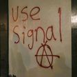 Grafitti urging people to use Signal, a highly-encrypted messaging app, is spray-painted on a wall during a protest in Berkeley, California