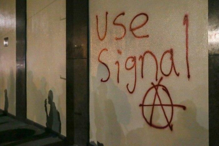 Grafitti urging people to use Signal, a highly-encrypted messaging app, is spray-painted on a wall during a protest in Berkeley, California