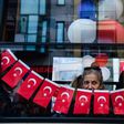 A woman looks from a window during a protest against the result of the nationwide referendum that will enhance the powers of President Erdogan powers in Istanbul on April 23, 2017