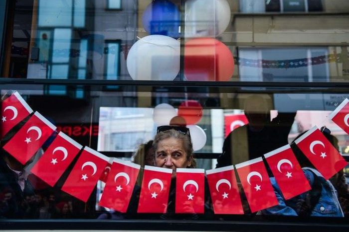 A woman looks from a window during a protest against the result of the nationwide referendum that will enhance the powers of President Erdogan powers in Istanbul on April 23, 2017